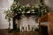 Elegant grey brick fireplace full of flowers and candles. Elegant room. Wedding decorated area. Vintage decor interior