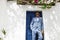 Elegant handsome man in blue suit is posing near in Fira in Santorini. Groom. Engagement and wedding in Santorini island of Greece