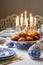 Elegant Hanukkah Celebration: Menorah, Traditional Foods, and Festive Decor