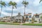 Elegant houses along road lined with tall palm trees in Long Beach California