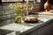 Elegant kitchen design with a sunlit window, sage green counter, and induction stove