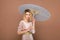 Elegant lady in chenille suit with parasol