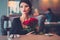 Elegant lady with red roses in restaurant