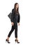 Elegant Latin business female in black suit and handbag walking side view