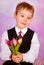 Elegant little boy with bunch of tulips