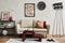 Elegant living room interior composition with beige sofa, black console, coffee table, mock up poster frame and creative design.