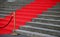 Elegant long red carpet on the wide steps of historic building