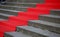 Elegant long red carpet on the wide steps of historic building