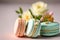 Elegant macarons close up image. Decoration with flowers over pastel background.