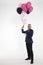 An elegant man with balloons invites to his company