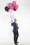 An elegant man with balloons invites to his company