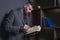 Elegant man in business suit with book. Portrait of handsome stylish man in library. Lawyer reads the book