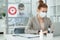 Elegant man in protective mask networking in office in front of female colleague