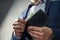 Elegant man in suit pulls out his money from wallet