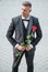 elegant man in tuxedo. man wear bowtie suit outdoor. handsome tuxedo man with red rose