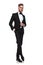 Elegant man in tuxedo standing with legs crossed