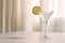 Elegant martini glass with fresh cocktail and lemon slice on beige marble table indoors. Space for text