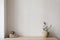 Elegant Mediterranean interior. Vintage vase with olive tree branches, cup of coffee. Books on wooden table. Living room