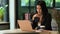 Elegant millennial businesswoman watching online webinar, reading email on her laptop computer