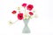 Elegant mixed ranunculus spring bouquet in white vase on white background. Spring buttercups.