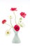 Elegant mixed ranunculus spring bouquet in white vase on white background. Spring buttercups.