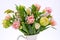 Elegant mixed tulips spring bouquet in white vase on white background with copy space. Spring tulips. Tulips bouquet.