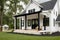 elegant and modern farmhouse exterior with black siding, white trim, and a porch swing