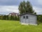 Elegant modern wooden garden shed with lush green lawn