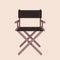 Elegant movie director`s chair on the beige background. Movie industry, directing, acting, concept.