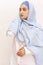 Elegant Muslim woman in white shirt and bright blue hijab. Stylish Iranian girl in Muslim clothing. Isolated portrait of