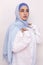 Elegant Muslim woman in white shirt and bright blue hijab. Stylish Iranian girl in Muslim clothing.  portrait of