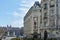 Elegant neoclassical building in the Barrio de las letras, with the neptune fountain in the background, in the downtown