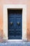 Elegant old blue double door entrance of building in Europe. Vintage wooden doorway of ancient stone house. Simple