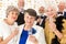 Elegant older friends make a toast with champagne during the birthday party