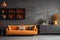 Elegant orange sofa against grey stucco wall and cabinet. Scandinavian style home interior design