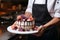 Elegant pastry mastery hands cradle a divine mousse cake