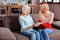 Elegant pensioner examining beautiful engagement ring of her relative