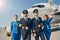 Elegant pilots and slim stewardesses looking ahead