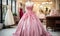 Elegant pink strapless ball gown on mannequin in a bridal boutique with various wedding dresses in the background, romantic bridal