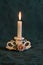 Elegant porcelain candlestick with burning candle