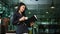 Elegant professional businesswoman holding coffee cup and reading reports in modern office