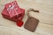 Elegant red gift box stack decorated with mini heart figure on wood background, valentine love present concept