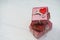 Elegant red gift boxes stack decorated with mini heart figure on white wood background, valentine love present concept