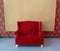 Elegant red sofa with blank backdrop