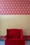 Elegant red sofa with blank backdrop