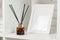 Elegant Reed Diffuser on White Shelf in a Modern Minimalist Interior Setting