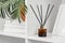 Elegant Reed Diffuser on White Shelf in a Modern Minimalist Interior Setting