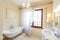 Elegant and rich Bathroom in a classic style in beige tones. Elegant bathroom, washbasin with mirror, window