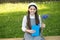 Elegant schoolgirl child girl with book in park, school library concept