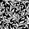 Elegant seamless pattern. Tracery of swirls and decorative leaves on a black background. Vintage style.